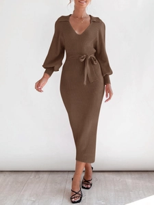 Detail of V-neck ribbed knit midi dress with lantern sleeves and a waist tie belt