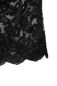 Dettaglio ravvicinato di pizzo floreale nero con bordi smerlati e motivi floreali eleganti