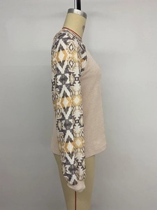 Detail of waffle knit fabric and geometric tribal pattern on long sleeve top