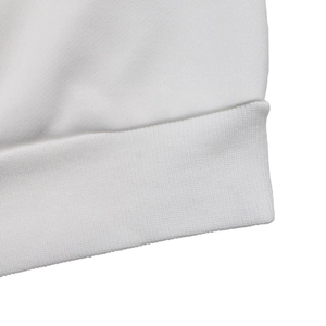 Close-up of fine ribbed cuff and texture on a loose white crewneck sweatshirt
