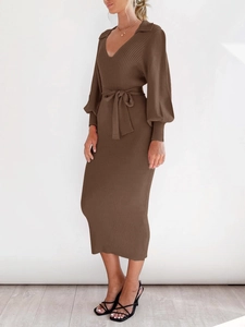 Detail of V-neck knitted dress in dark brown with ribbed texture and waist tie