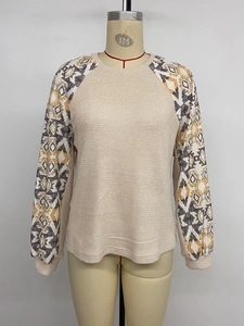 Detailed texture of waffle knit fabric and geometric ethnic print on long sleeves