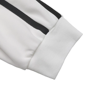 Detail of ribbed cuffs and black double stripes on white long sleeve sweatshirt