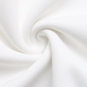 Detailed macro view of the soft white knitted fabric texture on women's sweatshirt