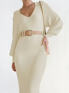 Detail of V-neck knit midi dress featuring lantern sleeves and khaki belt with gold buckle