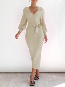 Detail of V-neck knitted maxi dress featuring lantern sleeves and vertical ribbed texture