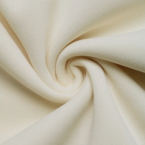 Detailed macro view showing the soft texture of high-quality cream knitted fabric material