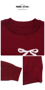 Close-up of ribbed crewneck and cuffs on burgundy Christmas sweater with bow jacquard