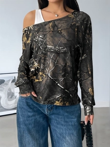 Detail of forest camouflage print and off-shoulder design on this long-sleeve top