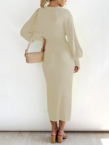 Rear view of beige ribbed knit maxi dress with lantern sleeves and tied high waist detail