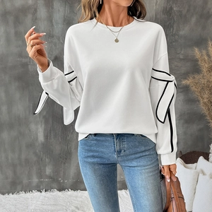 Women's casual white crew neck sweatshirt with contrast black bow ties on long sleeves
