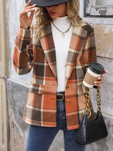 Detail of vintage plaid blazer coat with notched lapel and classic flap pockets