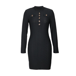 Detailed view of black bodycon knit dress with decorative brown buttons and pocket accents