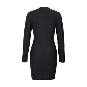 Macro shot of the black textured knit fabric and bodycon fit on the back of this dress