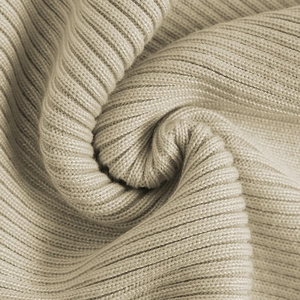 Close-up of beige ribbed knit fabric showing soft texture and high-quality stitch detail