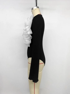 Detailed side view of long sleeve bodysuit featuring large white organza floral ruffles