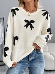 Women's cream knit sweater with black bow jacquard pattern in a relaxed fit