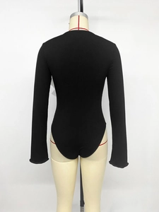 Detailed back view of a black ribbed knit long-sleeved bodysuit with a slim-fit design