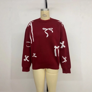 Women's burgundy Christmas sweater with white bow patterns on mannequin display
