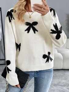 Women's white crewneck sweater with black bow jacquard patterns for a chic casual style