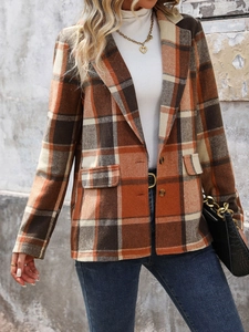 Detailed view of vintage plaid blazer fabric texture with flap pocket and button closure