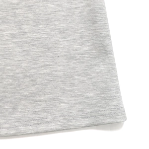 Close-up of grey marl jersey flared trousers showing high-quality double-needle hem stitching