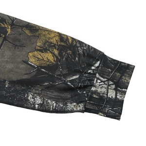 Close-up of the elastic cuff on a long-sleeve camouflage top with forest leaf patterns