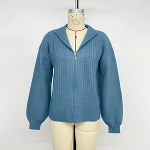 Gilet en maille bleue avec col montant, fermeture éclair et détails texturés verticaux