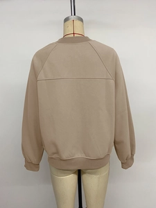 Back view of a camel-colored casual jacket featuring raglan sleeves and ribbed cuffs