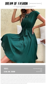 Detail of dark green sleeveless pleated dress featuring a stylish waist tie belt