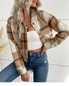 Close-up of brown and beige flannel plaid shacket featuring soft brushed texture and front buttons