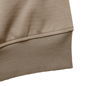 Detail of ribbed hem and high-quality knit texture on a casual khaki autumn jacket