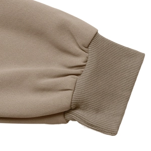 Close-up of khaki knit sleeve with ribbed cuffs on a loose-fitting casual autumn jacket
