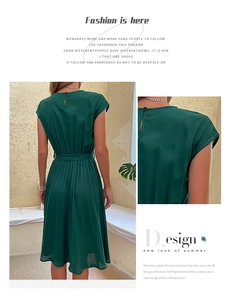 Detail of dark green sleeveless pleated dress featuring waist tie and back button closure