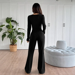 Slim fit black long sleeve jumpsuit with backless U-neck and high waist flare pants