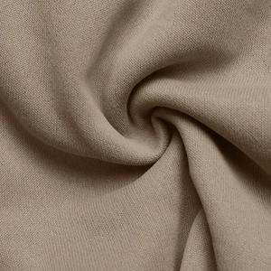 Macro shot of high-quality taupe knit fabric texture with soft drapes and smooth finish