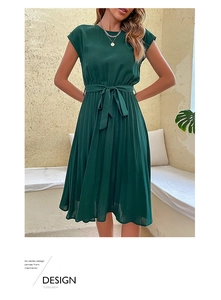 Detail of dark green pleated dress featuring a round neck and waist tie for casual wear