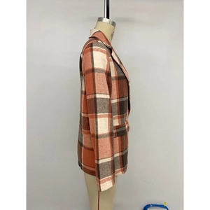 Vintage orange plaid wool coat featuring a notched lapel and long sleeves on a mannequin