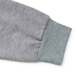 Detailed macro view of the heather grey ribbed cuffs and knitted fabric texture
