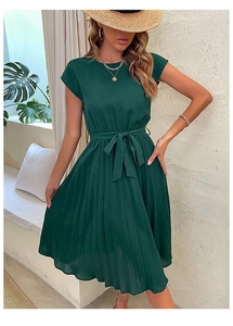 Detailed view of the dark green pleated dress featuring a tied bow belt and a-line hemline