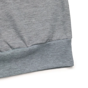 Detailed macro view of the grey ribbed cuffs and stitching on the cotton blend sweatshirt