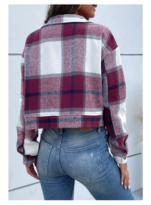 Detail of red and blue flannel cropped plaid jacket with long sleeves and classic lapel