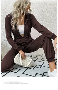 Detail of dark brown long sleeve hooded jumpsuit with metal zipper and elastic waist