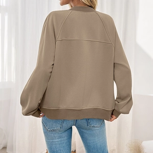 Woman in casual oversized khaki jacket and classic blue jeans, stylish back view