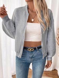 Detail of gray zip-up fleece sweatshirt with drop shoulders and ribbed cuffs on model
