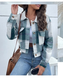 Close-up of green plaid flannel jacket featuring classic collar and button-flap chest pockets