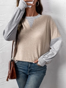 Detail of color-block crewneck sweatshirt with V-stitch neckline and knit texture