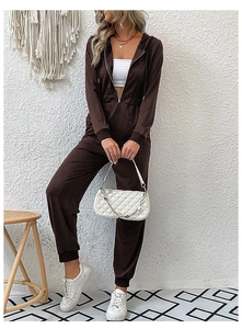 Detailed shot of dark brown hooded jumpsuit with metal zipper and ribbed cuffs for women