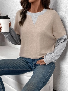 Detail of color-block crewneck sweatshirt showing contrast gray sleeves and khaki bodice