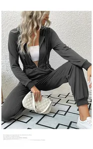 Detail of dark grey hooded jumpsuit with elastic waist and front zipper closure
